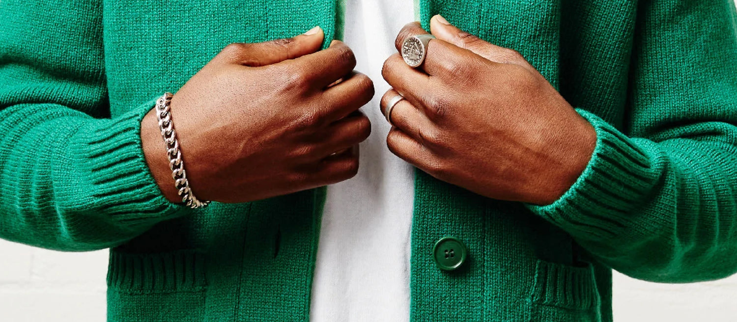 A man wearing a bright green cardigan sweater